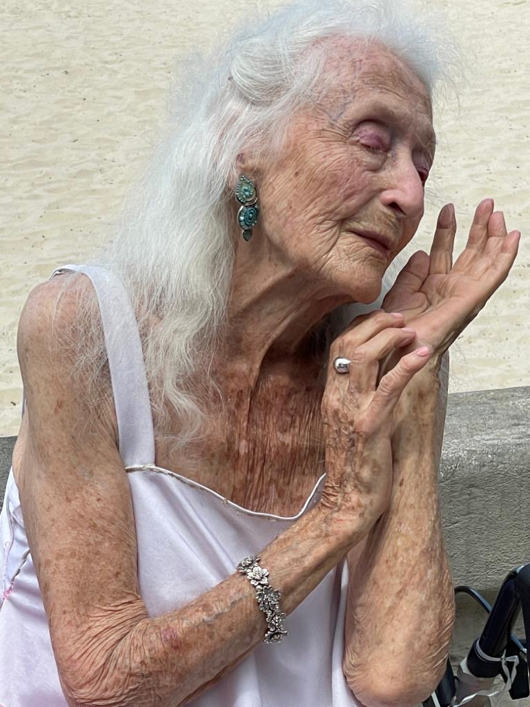 Eileen in a dance pose with beach in the background