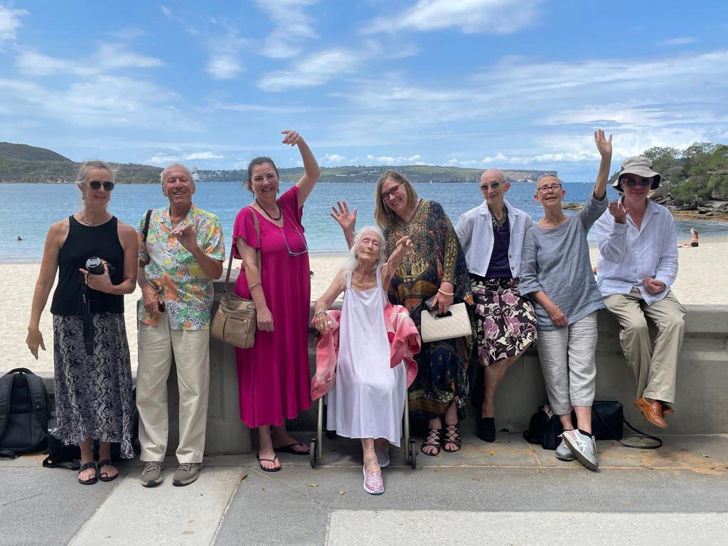 Eileen and friends sitting on the wall at Balmoral.