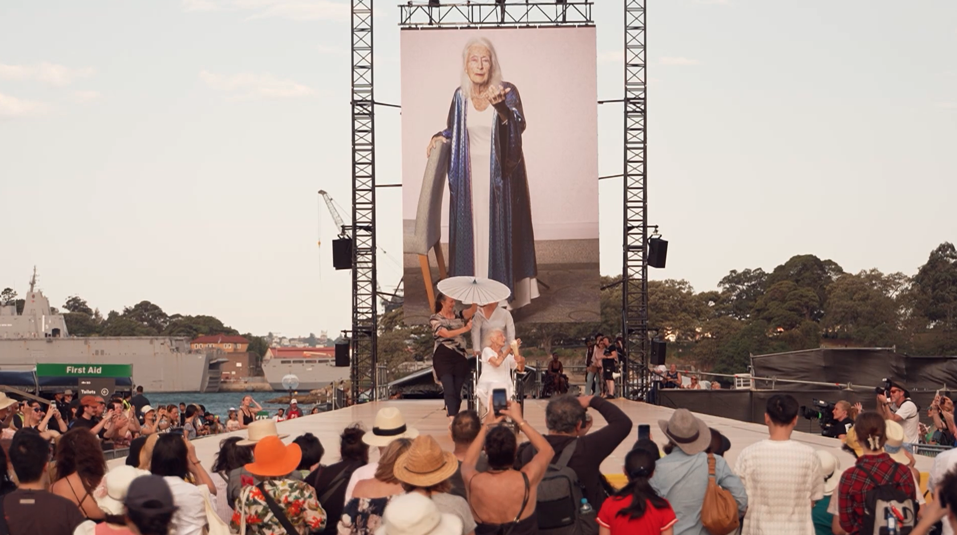 Eileen on the catwalk for 'What Is the City but the People', with a large photographic portrait of her in the background.