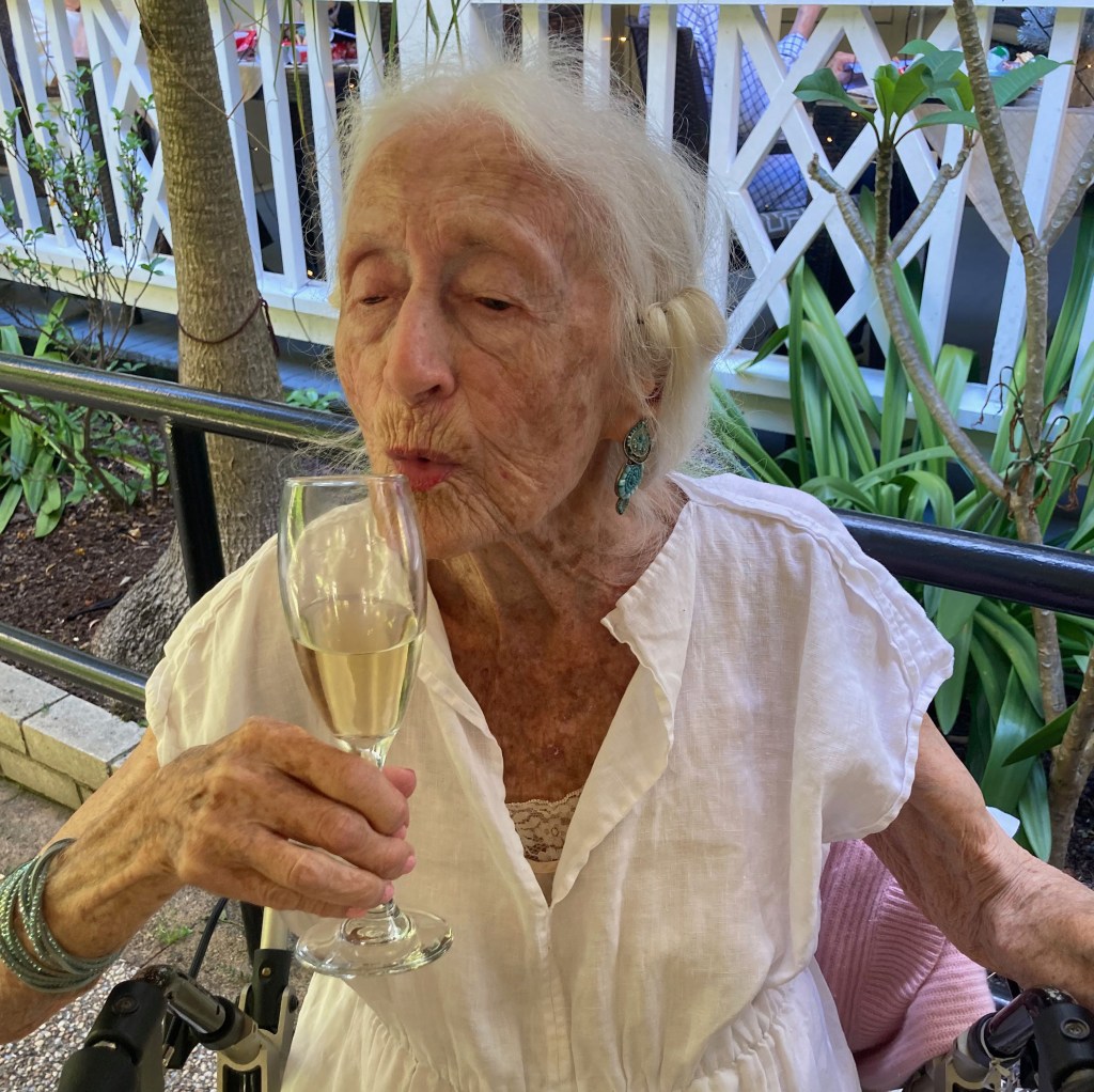 Eileen Kramer with a glass of champagne